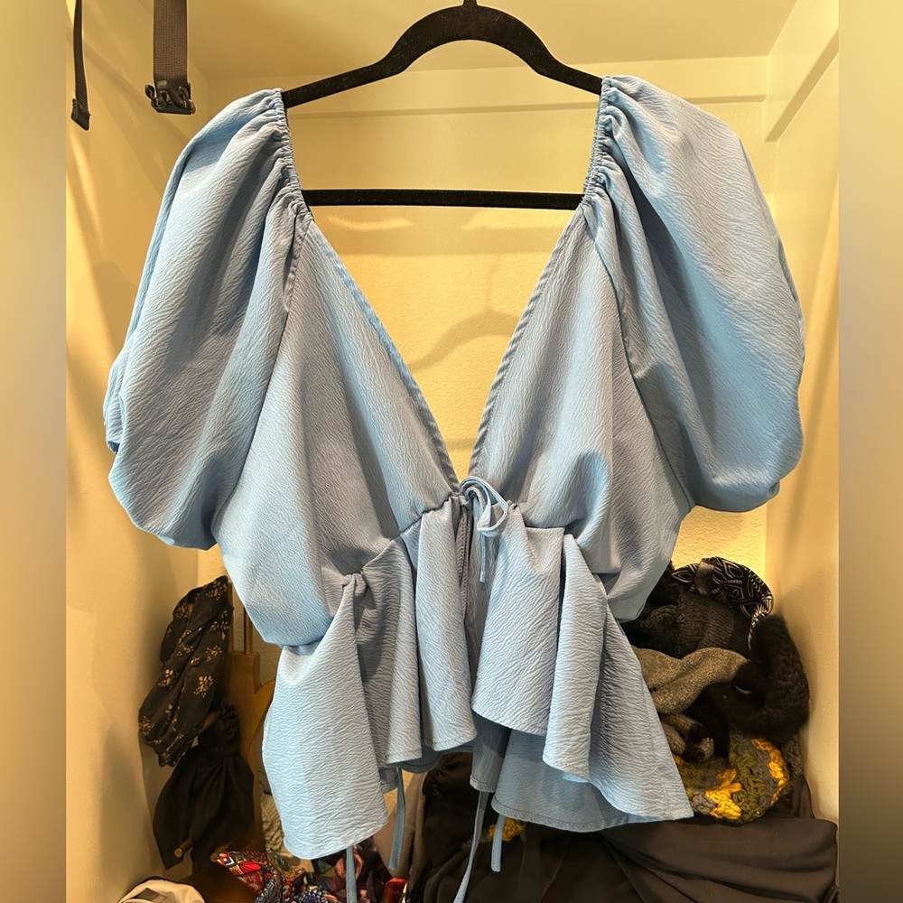 Blue peplum style top with cap sleeves.